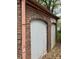 Exterior wall with rustic brickwork and arched garage doors, adding character to the property's facade at 240 Mathewson Sw, Atlanta, GA 30314