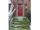 Entryway with brickwork and steps leading to a red front door offers a classic yet unkempt arrival at 240 Mathewson Sw, Atlanta, GA 30314
