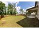 Expansive backyard with a covered patio, wooden fence, and mature trees, perfect for outdoor activities at 446 Noblewood Dr, Mcdonough, GA 30252
