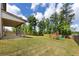Spacious backyard featuring a covered patio, a wooden fence, and a playset at 446 Noblewood Dr, Mcdonough, GA 30252