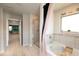 Bright bathroom featuring a soaking tub, glass-enclosed shower and modern decor at 446 Noblewood Dr, Mcdonough, GA 30252