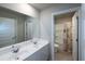 Bright bathroom showcasing double vanity sinks, large mirror, and adjacent toilet and tub with shower at 446 Noblewood Dr, Mcdonough, GA 30252