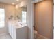 Bathroom featuring double sinks, a large mirror, and bright natural light at 446 Noblewood Dr, Mcdonough, GA 30252