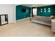 Spacious bedroom featuring plush carpeting, teal accent wall, and a four-poster bed frame at 446 Noblewood Dr, Mcdonough, GA 30252