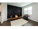 Bedroom with a black accent wall, window and hardwood floors at 446 Noblewood Dr, Mcdonough, GA 30252