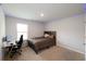 Bedroom featuring neutral walls and carpeting, a dark wood bed frame, and a workspace at 446 Noblewood Dr, Mcdonough, GA 30252