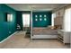 Spacious bedroom featuring a four-poster bed frame, teal accent wall and a window at 446 Noblewood Dr, Mcdonough, GA 30252