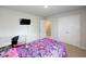 Bedroom featuring a bed, desk, mounted TV, and closet with double doors at 446 Noblewood Dr, Mcdonough, GA 30252