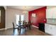 Elegant dining room with a dark wood table, chandelier, and a striking red accent wall at 446 Noblewood Dr, Mcdonough, GA 30252