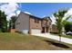 Well-kept home with a brick facade, two-car garage, and a neatly landscaped front yard at 446 Noblewood Dr, Mcdonough, GA 30252