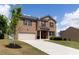 Charming brick home featuring a two-car garage, manicured lawn, and a classic architectural style at 446 Noblewood Dr, Mcdonough, GA 30252