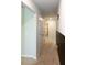 Hallway featuring neutral walls and carpeting, a utility closet, and plenty of natural light at 446 Noblewood Dr, Mcdonough, GA 30252