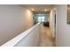 Bright hallway with neutral colors, leading to a cozy seating area with large windows at 446 Noblewood Dr, Mcdonough, GA 30252