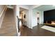 Bright hallway with hardwood floors and staircase at 446 Noblewood Dr, Mcdonough, GA 30252