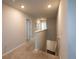 Upstairs hallway with neutral walls, carpeted floor, and white trim leading to the bedrooms at 446 Noblewood Dr, Mcdonough, GA 30252