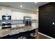Modern kitchen featuring granite countertops, stainless steel appliances, and a unique chalkboard wall at 446 Noblewood Dr, Mcdonough, GA 30252