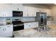 Well-equipped kitchen with granite counters, stainless appliances, and sleek white cabinetry at 446 Noblewood Dr, Mcdonough, GA 30252