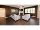 Cozy living room featuring a fireplace, large windows, and hardwood floors at 446 Noblewood Dr, Mcdonough, GA 30252