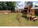 Backyard featuring a wooden playset and a fire pit area, perfect for Gathering fun and relaxation at 446 Noblewood Dr, Mcdonough, GA 30252