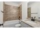 Bathroom with tub/shower combo, tiled wall, granite countertop, and neutral color scheme at 103 Mission Se Way # 103, Atlanta, GA 30315