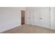 Minimal bedroom featuring a neutral wall, plush carpet, and a double door closet at 103 Mission Se Way # 103, Atlanta, GA 30315