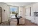 Bright dining area with a round table, stylish chairs, and a large window with natural light at 103 Mission Se Way # 103, Atlanta, GA 30315