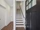 Bright entryway featuring hardwood floors, staircase and natural light from the front door window at 103 Mission Se Way # 103, Atlanta, GA 30315