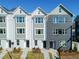 Charming new construction townhomes with painted brick and landscaped yards under clear, sunny skies at 103 Mission Se Way # 103, Atlanta, GA 30315