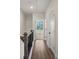 Upstairs hallway featuring wood floors, white trim, and natural light streaming through a window at 103 Mission Se Way # 103, Atlanta, GA 30315