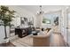 Inviting living room with modern lighting, neutral decor, and a door leading to a deck at 103 Mission Se Way # 103, Atlanta, GA 30315