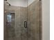 Tiled walk-in shower with frameless glass door and matte black hardware at 103 Mission Se Way # 103, Atlanta, GA 30315