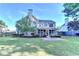 Expansive backyard with lush lawn, mature trees, and patio area for outdoor enjoyment at 2049 Mclain Nw Rd, Acworth, GA 30101
