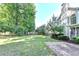 Large fenced-in backyard with green grass and mature trees, perfect for outdoor activities at 2049 Mclain Nw Rd, Acworth, GA 30101