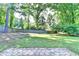 Spacious fenced-in backyard with lush lawn, mature trees, and paver patio at 2049 Mclain Nw Rd, Acworth, GA 30101