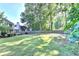 Large fenced-in backyard with mature trees providing shade and privacy at 2049 Mclain Nw Rd, Acworth, GA 30101