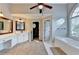 Bright bathroom features a vanity, carpeted floors, and access to an open shower at 2049 Mclain Nw Rd, Acworth, GA 30101