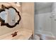 Cozy bathroom features ornate mirror, sink with bronze fixtures and shower-tub combination at 2049 Mclain Nw Rd, Acworth, GA 30101