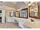 Bathroom featuring a double sink vanity with a large mirror and an open doorway at 2049 Mclain Nw Rd, Acworth, GA 30101