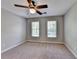 Bedroom featuring carpet, neutral walls, ceiling fan, and windows for natural light at 2049 Mclain Nw Rd, Acworth, GA 30101