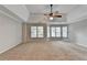 Spacious bedroom with tray ceiling, carpet, ceiling fan, and bay window at 2049 Mclain Nw Rd, Acworth, GA 30101