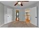 A comfortable bedroom features neutral walls, a ceiling fan, carpet, and white paneled doors at 2049 Mclain Nw Rd, Acworth, GA 30101