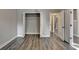 Bright bedroom with hardwood flooring and access to a closet and hallway at 2049 Mclain Nw Rd, Acworth, GA 30101