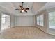 A Primary bedroom features tray ceilings, carpet, ceiling fan, and access to an outdoor patio at 2049 Mclain Nw Rd, Acworth, GA 30101