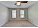 Bedroom featuring carpet, neutral walls, ceiling fan, and windows for natural light at 2049 Mclain Nw Rd, Acworth, GA 30101