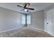 A cozy bedroom features neutral walls, ceiling fan, carpet, and natural light from the window at 2049 Mclain Nw Rd, Acworth, GA 30101