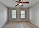 Bedroom featuring carpet, neutral walls, ceiling fan, and windows for natural light at 2049 Mclain Nw Rd, Acworth, GA 30101