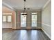 Cozy dining room filled with natural light, crown molding, neutral walls, and gray wood-look flooring at 2049 Mclain Nw Rd, Acworth, GA 30101