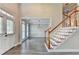 Bright foyer with hardwood floors, staircase with wooden banister, and front door access at 2049 Mclain Nw Rd, Acworth, GA 30101
