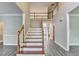 Spacious two-story foyer featuring hardwood floors, staircase with wooden banister and views into living spaces at 2049 Mclain Nw Rd, Acworth, GA 30101
