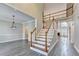 Spacious two-story foyer featuring hardwood floors, staircase with wooden banister and views into living spaces at 2049 Mclain Nw Rd, Acworth, GA 30101